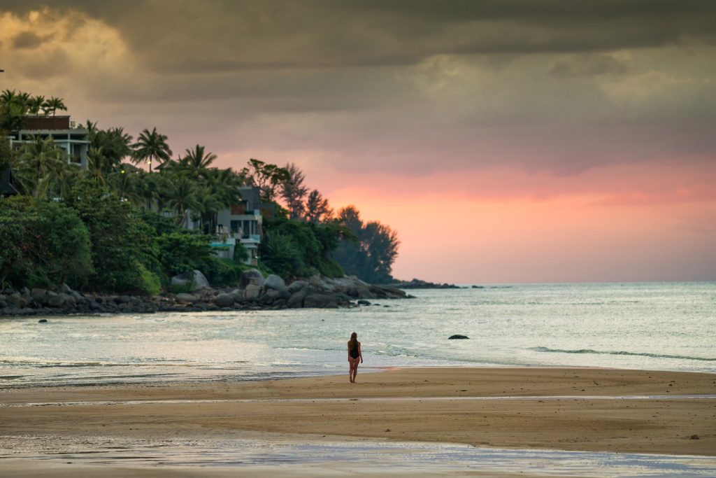 Lone girl on beach during sunset
