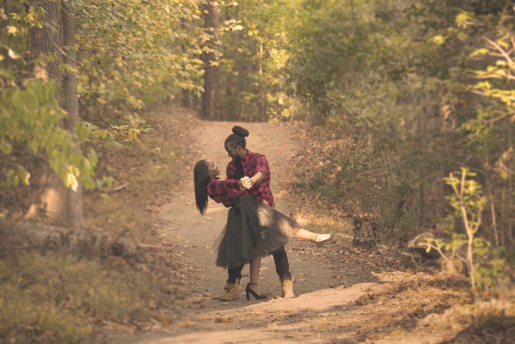 Black couple dancing in woods